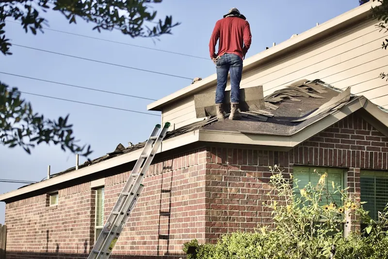 Professional roofer working on a residential roof in Riverhead